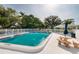 Community pool with lounge chairs and picnic tables at 4550 Overlook Ne Dr # 258, St Petersburg, FL 33703