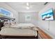 Well lit bedroom with queen bed and TV at 5135 River Point Ct, New Port Richey, FL 34653
