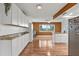 Updated kitchen with granite countertops, white cabinets, and wood-look floors at 5135 River Point Ct, New Port Richey, FL 34653