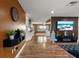 Open living area with L-shaped sofa and wood-look floors at 5135 River Point Ct, New Port Richey, FL 34653