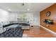 Living room with L-shaped sectional and wood-look floors at 5135 River Point Ct, New Port Richey, FL 34653
