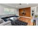 Living area featuring an L-shaped sectional and accent wall at 5135 River Point Ct, New Port Richey, FL 34653
