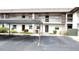 Condo building exterior with parking and landscaping at 5197 Silent Loop # 121, New Port Richey, FL 34652