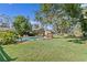 Large backyard with a refreshing blue pool and lush lawn at 5265 Venetian Ne Blvd, St Petersburg, FL 33703
