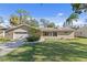 Ranch style home with attached two-car garage and spacious lawn at 5265 Venetian Ne Blvd, St Petersburg, FL 33703