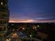 Stunning sunset view over water, with luxury condos and palm trees below at 555 5Th Ne Ave # 521, St Petersburg, FL 33701