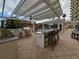 Outdoor kitchen with granite counters, grill, and bar seating under covered pergola at 555 5Th Ne Ave # 521, St Petersburg, FL 33701