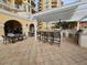 Outdoor kitchen area with grill, barstools, and dining tables at 555 5Th Ne Ave # 521, St Petersburg, FL 33701