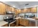 Kitchen with wood cabinets, granite counters and water views at 6287 Bahia Del Mar Cir # 208, St Petersburg, FL 33715