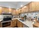 Kitchen with wood cabinets, granite counters, and stainless appliances at 6287 Bahia Del Mar Cir # 208, St Petersburg, FL 33715