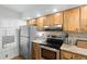 Kitchen boasts wood cabinets, granite counters, and stainless appliances at 6287 Bahia Del Mar Cir # 208, St Petersburg, FL 33715