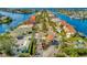 Picturesque aerial view of a community with waterfront homes, lush landscaping, and a tranquil waterway creating a serene environment at 808 Symphony Isles Blvd, Apollo Beach, FL 33572