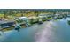 Aerial view of waterfront homes with docks and boatlifts, highlighting the community's access to waterways and outdoor amenities at 808 Symphony Isles Blvd, Apollo Beach, FL 33572