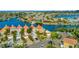 Stunning aerial view of waterfront townhomes, showcasing lush landscaping and a tranquil waterway for boating and relaxation at 808 Symphony Isles Blvd, Apollo Beach, FL 33572