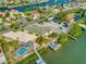 Breathtaking aerial view of waterfront homes, showcasing a pool, docks, and serene waterways at 808 Symphony Isles Blvd, Apollo Beach, FL 33572