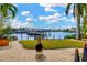 Waterfront backyard with a boat dock and outdoor fire pit seating area at 808 Symphony Isles Blvd, Apollo Beach, FL 33572