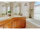 Elegant bathroom with double sinks, granite countertops, and a luxurious soaking tub for relaxation at 808 Symphony Isles Blvd, Apollo Beach, FL 33572