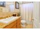 This updated bathroom has a stylish vanity with granite counters, toilet and a shower at 808 Symphony Isles Blvd, Apollo Beach, FL 33572