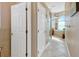 Bright bathroom features a soaking tub, tiled floors and ample natural light from large window at 808 Symphony Isles Blvd, Apollo Beach, FL 33572