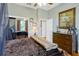 Stylish bedroom features hardwood floors, ceiling fan, and a comfortable bed with decor at 808 Symphony Isles Blvd, Apollo Beach, FL 33572
