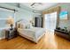 Bright and airy bedroom with a plush bed, ample natural light, and access to a private balcony at 808 Symphony Isles Blvd, Apollo Beach, FL 33572