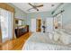 Comfortable bedroom with a large bed, dresser, and access to a closet and doorway at 808 Symphony Isles Blvd, Apollo Beach, FL 33572