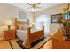 Comfortable bedroom features hardwood floors, ceiling fan, and a large bed with decorative pillows at 808 Symphony Isles Blvd, Apollo Beach, FL 33572