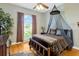 Stylish bedroom features hardwood floors, ceiling fan, and a comfortable bed with a canopy at 808 Symphony Isles Blvd, Apollo Beach, FL 33572