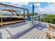 Waterfront deck with table, chairs, and boat dock at 808 Symphony Isles Blvd, Apollo Beach, FL 33572