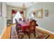 Formal dining room boasts a large mirror, chandelier, hardwood floors, and elegant decor at 808 Symphony Isles Blvd, Apollo Beach, FL 33572
