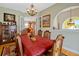 Spacious dining room featuring an elegant chandelier, hardwood floors, and french doors at 808 Symphony Isles Blvd, Apollo Beach, FL 33572