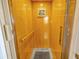 Residential elevator with wood paneled walls, a handrail, and a neutral-colored rug at 808 Symphony Isles Blvd, Apollo Beach, FL 33572