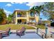 Stunning waterfront home boasts a dock, balcony, and lush landscaping for prime outdoor living at 808 Symphony Isles Blvd, Apollo Beach, FL 33572