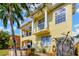 Rear exterior view featuring a hot tub, spiral staircase, and second-floor balcony at 808 Symphony Isles Blvd, Apollo Beach, FL 33572