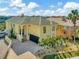 Stunning two-story home with a well-manicured lawn, palm trees, and a spacious driveway leading to a two-car garage at 808 Symphony Isles Blvd, Apollo Beach, FL 33572