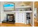 Fireplace with built-in shelving, drawers, and a flatscreen TV creates a focal point in the living space at 808 Symphony Isles Blvd, Apollo Beach, FL 33572