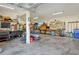 Spacious garage equipped with a variety of tools, storage solutions, and workspace areas at 808 Symphony Isles Blvd, Apollo Beach, FL 33572