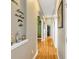 Hallway with hardwood floors and decorative art on the wall at 808 Symphony Isles Blvd, Apollo Beach, FL 33572
