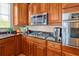 Well-equipped kitchen with stainless steel appliances, granite countertops, and rich wood cabinetry at 808 Symphony Isles Blvd, Apollo Beach, FL 33572
