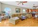Open living area with hardwood floors, large windows, and a seamless flow into the kitchen and outdoor spaces at 808 Symphony Isles Blvd, Apollo Beach, FL 33572