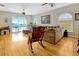 Comfortable living room featuring hardwood floors, rocking chair, and natural light flowing from the patio at 808 Symphony Isles Blvd, Apollo Beach, FL 33572