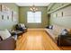 Inviting living room featuring hardwood floors, a cozy sofa, and stylish decor for comfortable living at 808 Symphony Isles Blvd, Apollo Beach, FL 33572