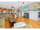 Spacious living room features hardwood floors, a cozy fireplace, and seamless access to the kitchen at 808 Symphony Isles Blvd, Apollo Beach, FL 33572