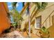 Side yard with well maintained landscape design and a brick paver walkway at 808 Symphony Isles Blvd, Apollo Beach, FL 33572