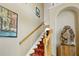 Carpeted staircase with wooden railing, leading to the upper level at 808 Symphony Isles Blvd, Apollo Beach, FL 33572