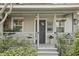 Inviting front porch with gray painted wood, hanging baskets, and decorative plants at 934 21St N Ave, St Petersburg, FL 33704