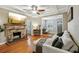 Living room with stone fireplace, hardwood floors, and a large TV at 934 21St N Ave, St Petersburg, FL 33704