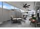 Covered patio with seating area and ceiling fans, overlooking the backyard at 10114 Chimney Hill Ct, Tampa, FL 33615