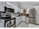 Kitchen with stainless steel appliances and white cabinets at 10114 Chimney Hill Ct, Tampa, FL 33615