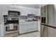 Kitchen with stainless steel appliances and white cabinets at 10114 Chimney Hill Ct, Tampa, FL 33615